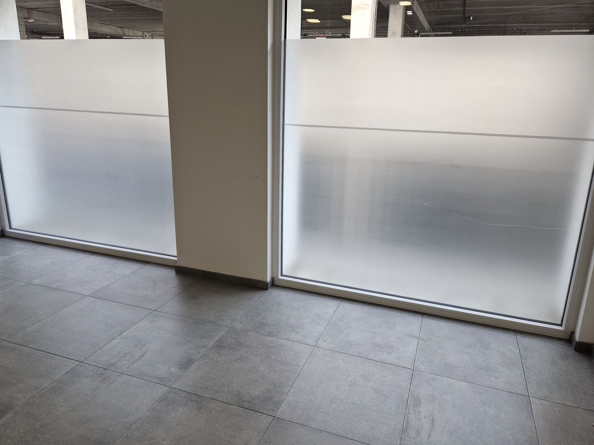 the vestibule has a view from the large windows blocking views of the hospital semi-transparent foil stickers stuck to the glass